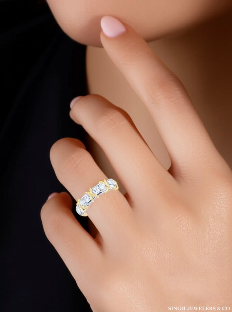 Gold ring with three diamonds on a hand, branded 'Singh Jewelers & Co'.