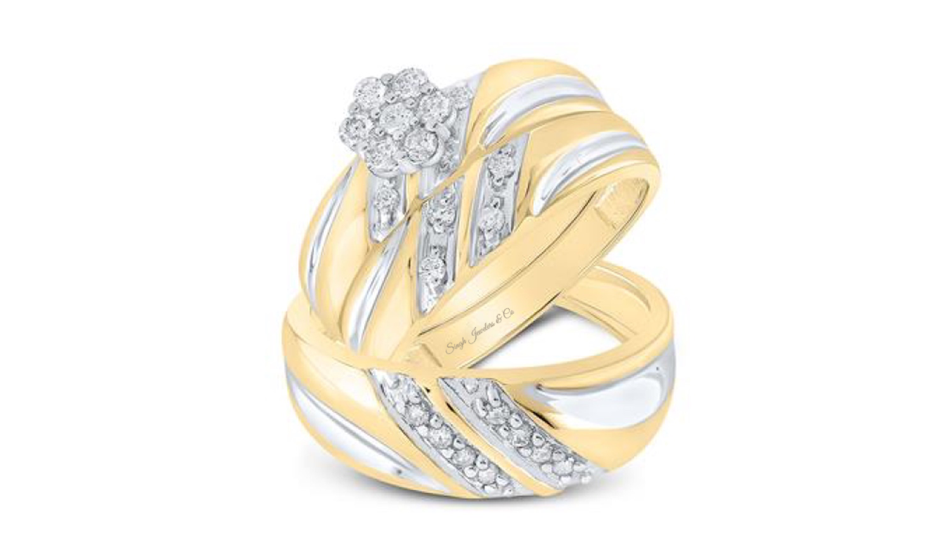 A trio set of interlinked gold and platinum rings, featuring diamond accents.