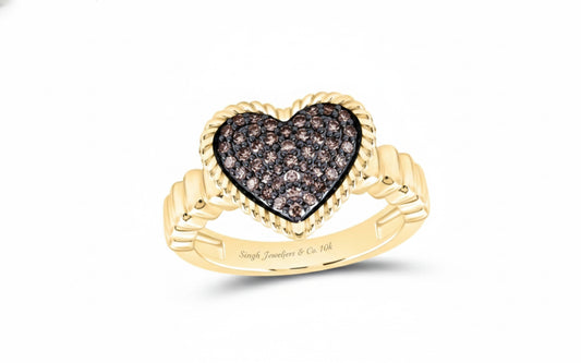 Gold ring with a heart-shaped diamond design on a white background