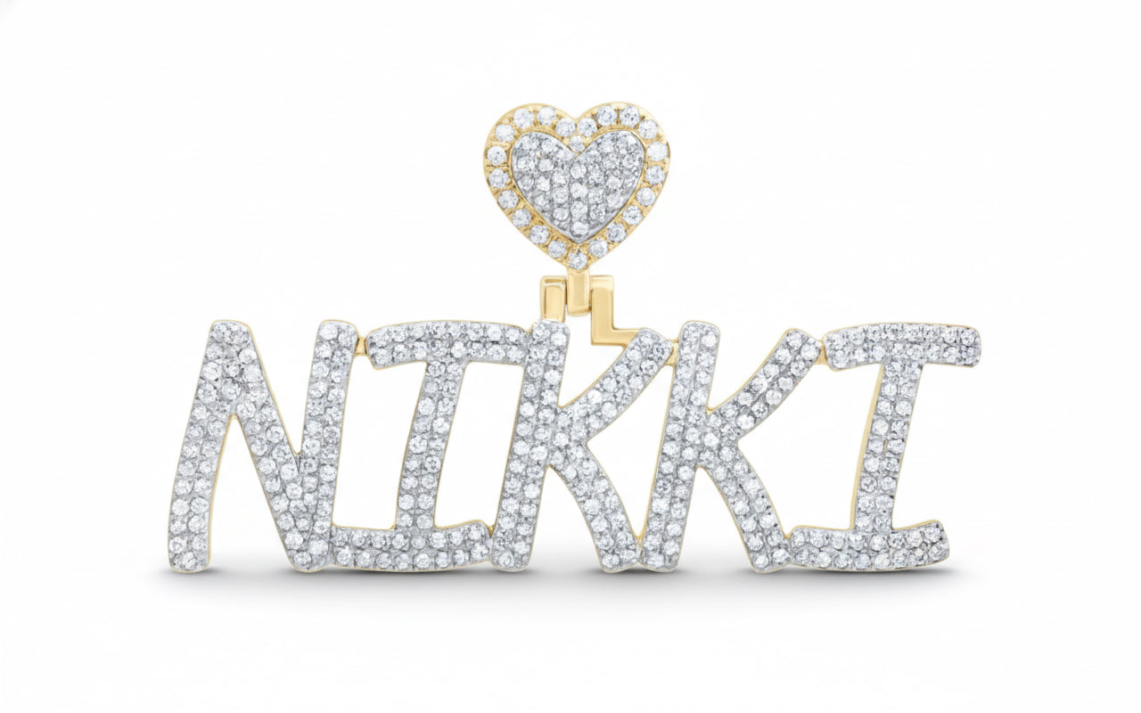 Diamond-encrusted name pendant with a heart-shaped charm on a white background
