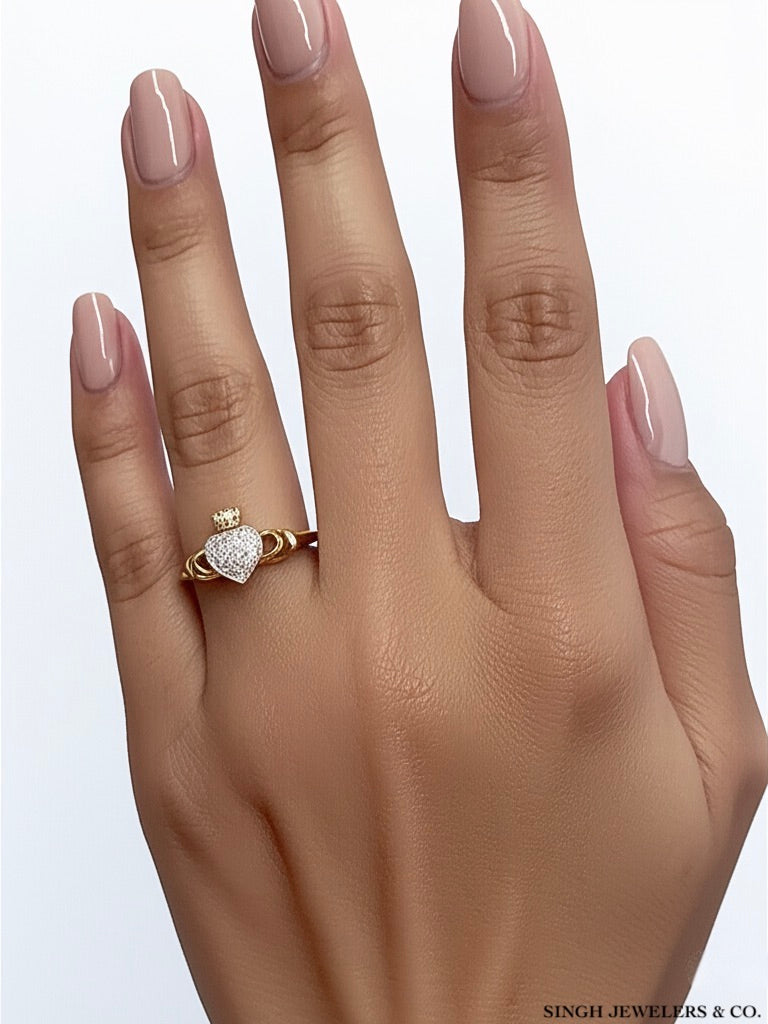 10K yellow gold Claddagh diamond ring worn on woman's hand