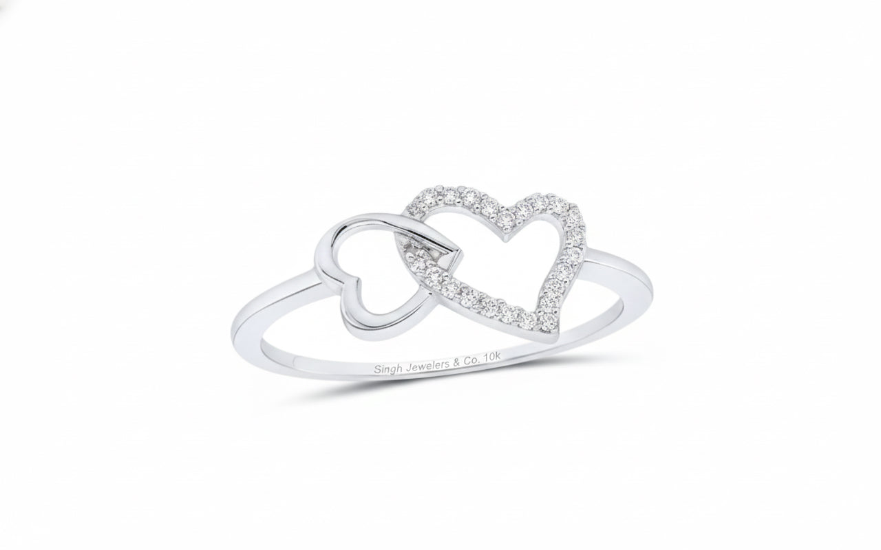 Silver ring with interlocking heart designs on a white background