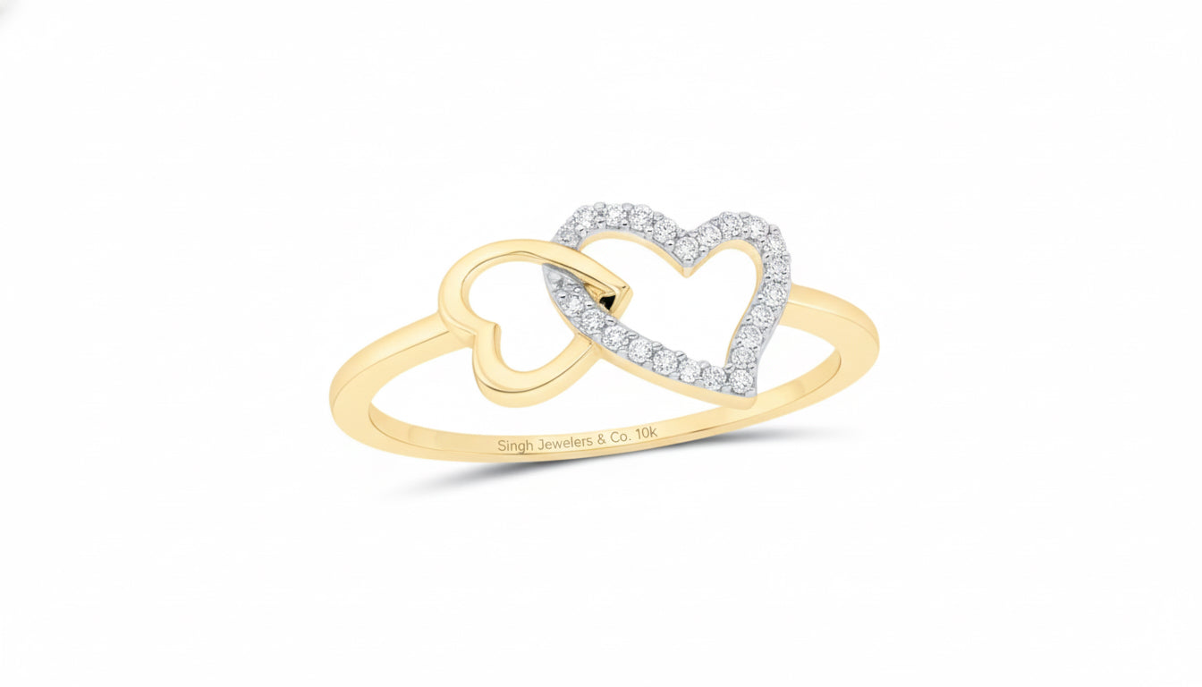 Gold and silver heart-shaped ring on a white background