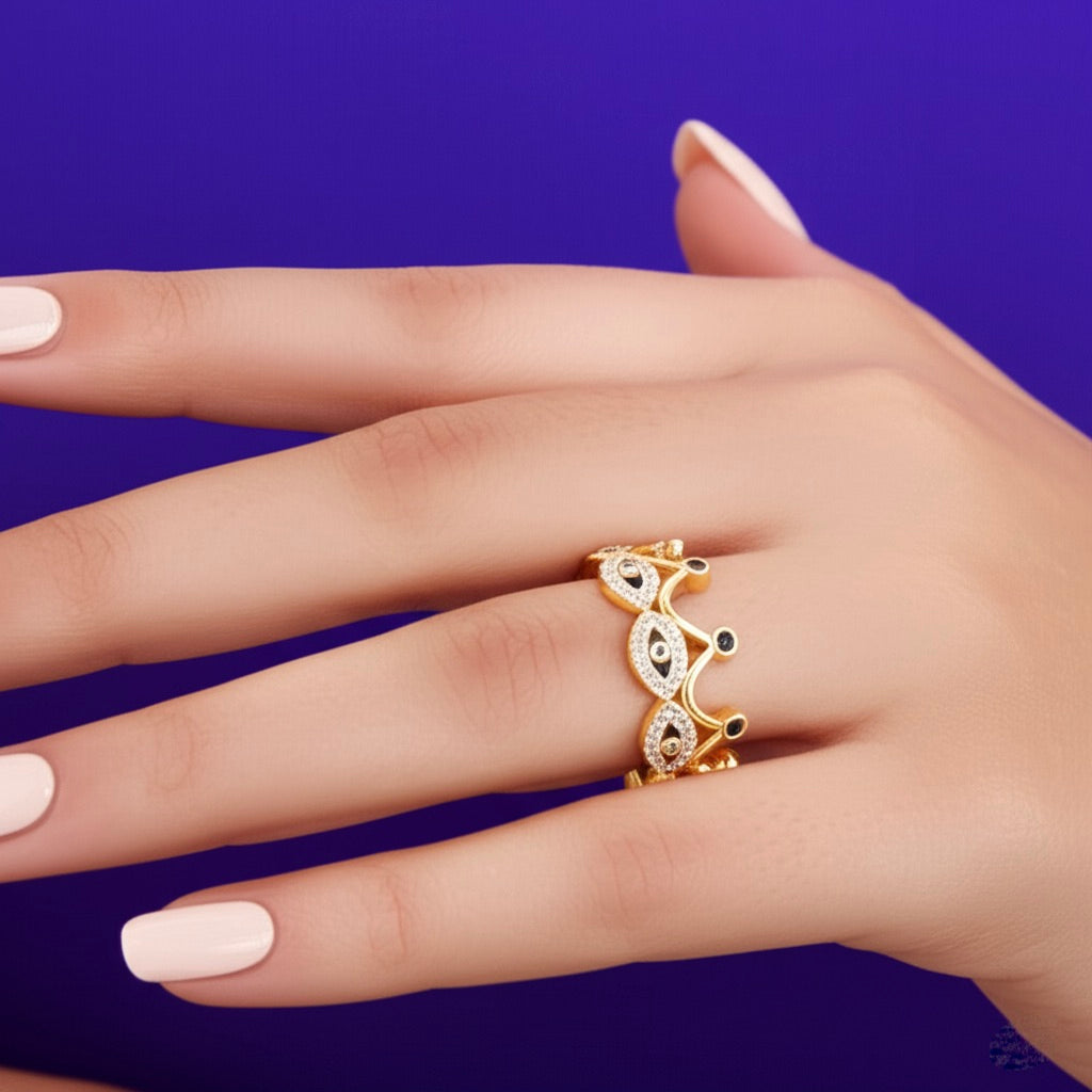 10K gold evil eye crown ring with black and blue enamel, featuring sparkling cubic zirconias