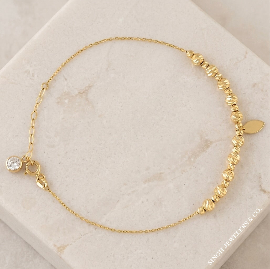 Women’s 10K yellow gold diamond cut anklet with white sapphire stones