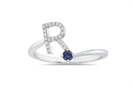 white gold ring with a blue sapphire on a white background