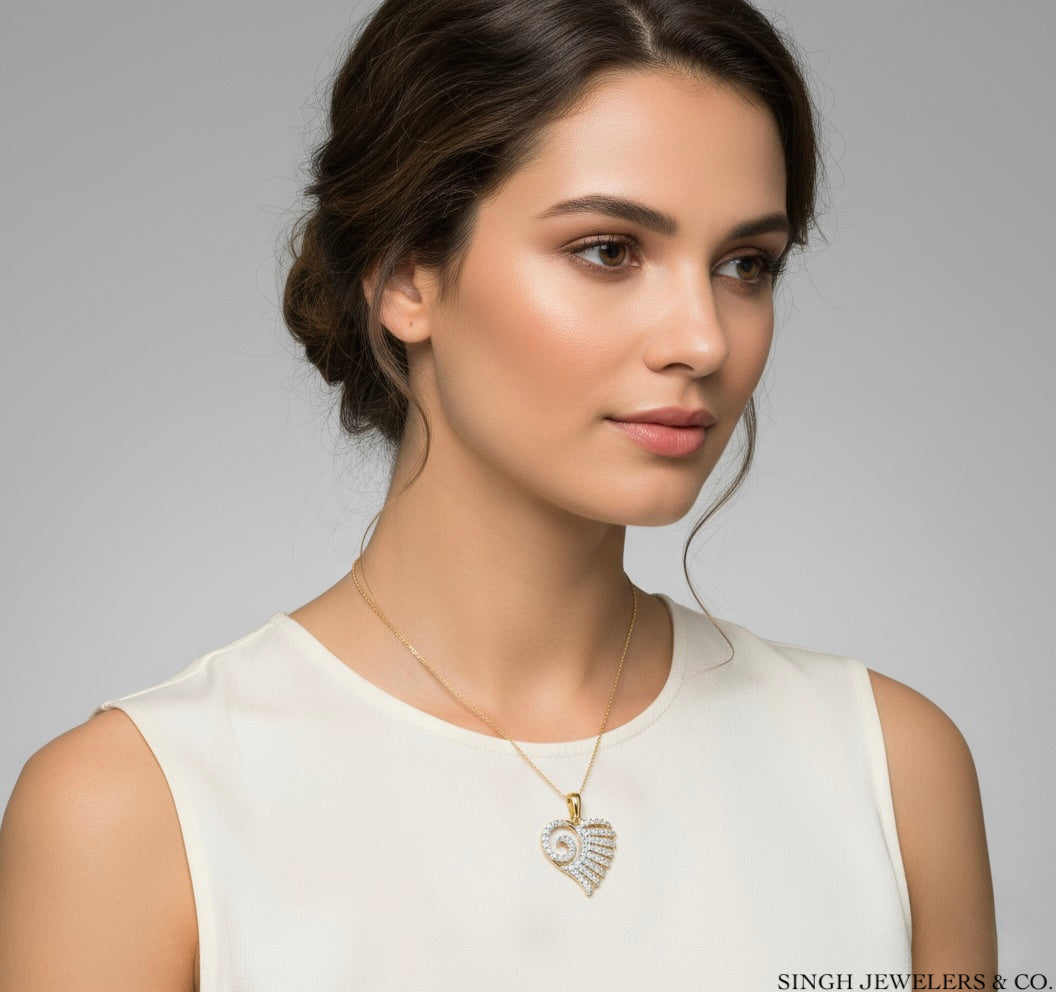 Woman wearing a gold necklace with a heart pendant on a gray background