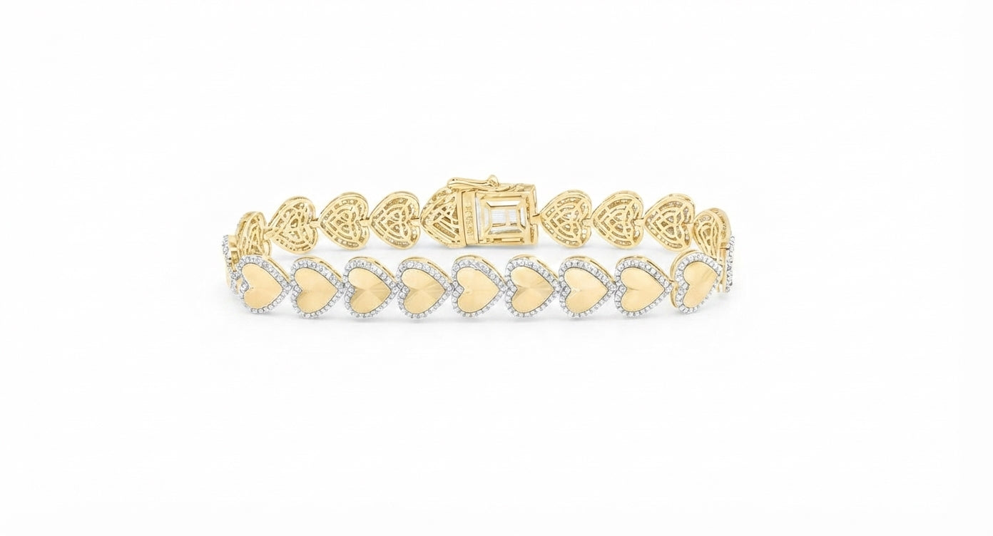 A yellow gold bracelet featuring a row of heart-shaped pavé settings with small clear stones and gold centers, displayed on a clean white background.