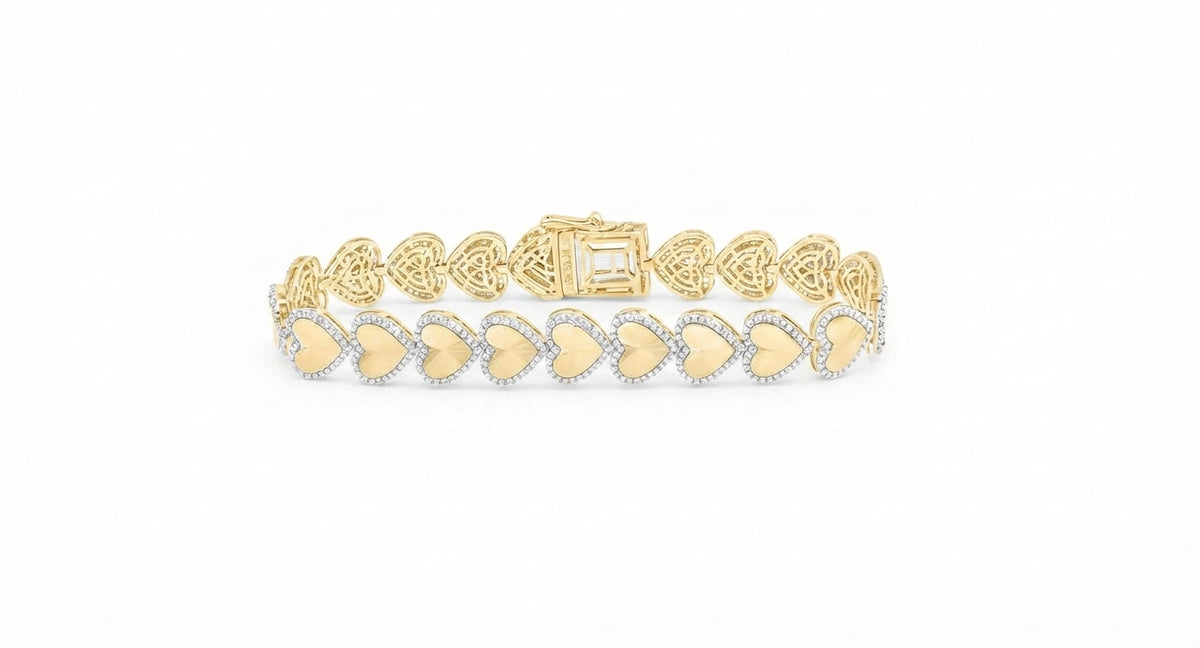 A yellow gold bracelet featuring a row of heart-shaped pavé settings with small clear stones and gold centers, displayed on a clean white background.