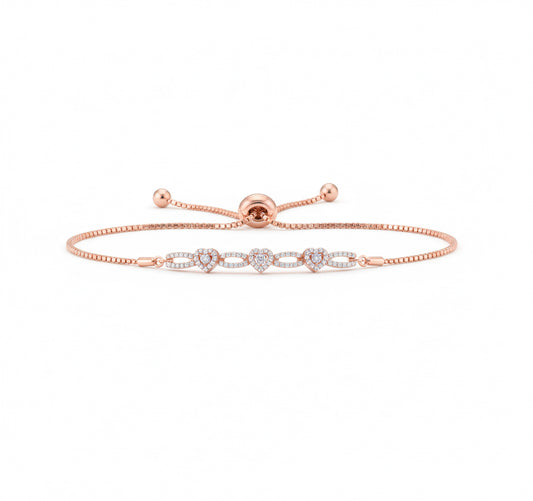 Rose gold bracelet with small heart charms on a white background