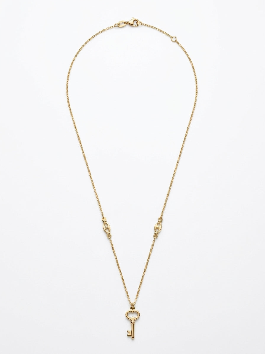 Close-up of a 10K gold puff link chain with key pendant