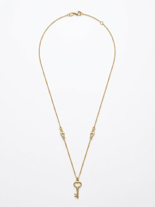 Close-up of a 10K gold puff link chain with key pendant