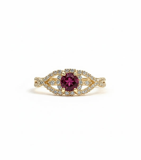 Gold ring with a red gemstone on a white background