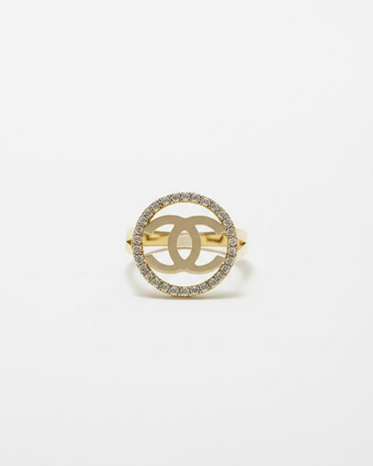 10K yellow gold split shank ring with white sapphires and white gold Chanel-style logo