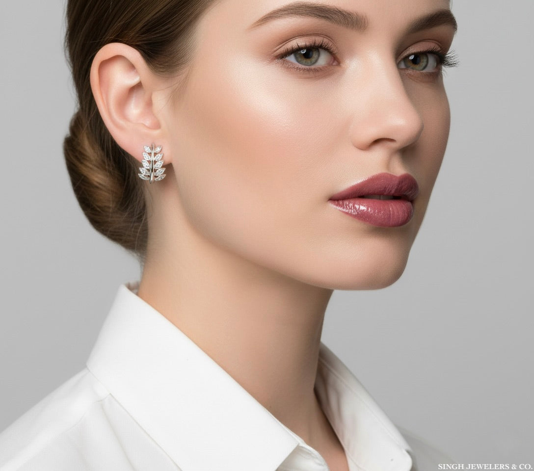 Close-up of a woman wearing diamond earrings with a neutral background