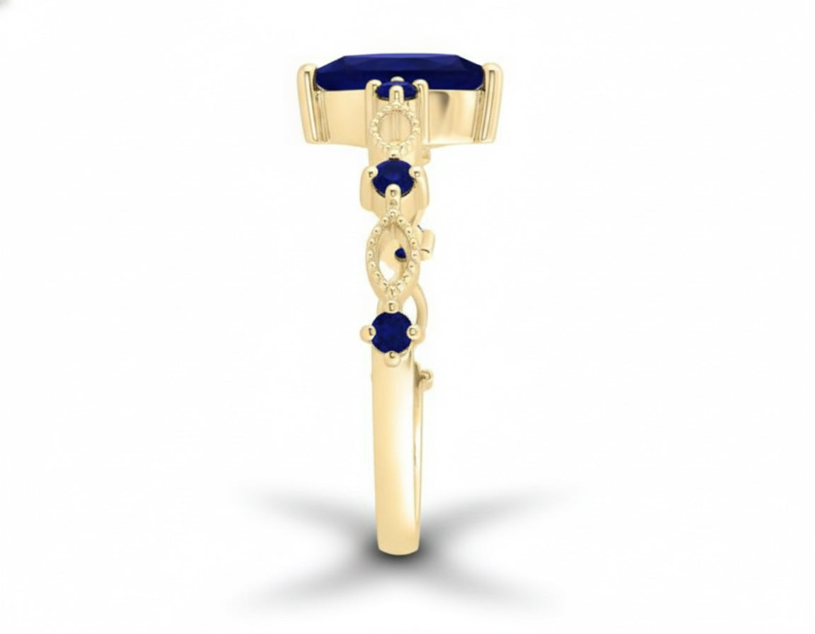 Gold ring with blue gemstones on a white background