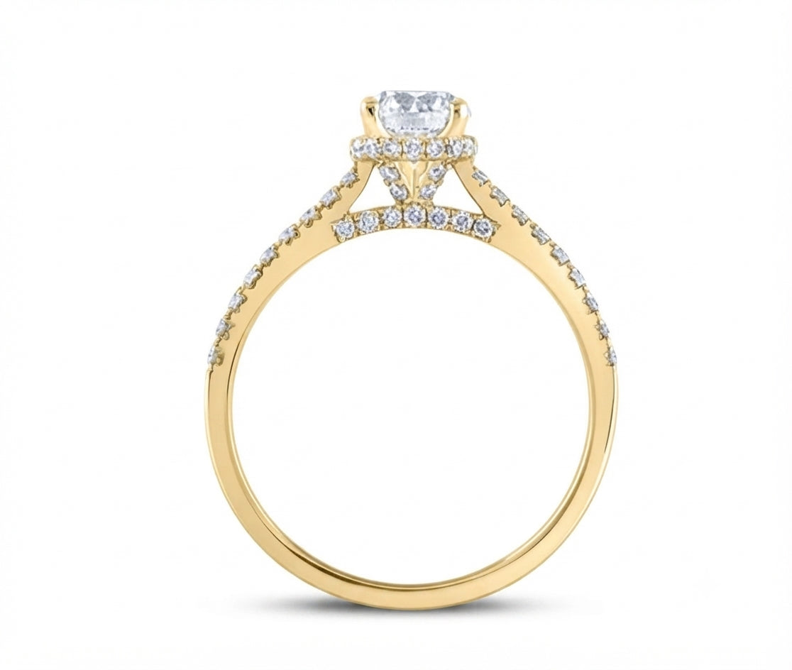 A yellow gold diamond ring with a marquise-cut center stone and pavé-set diamonds on the band, shown against a plain white background.