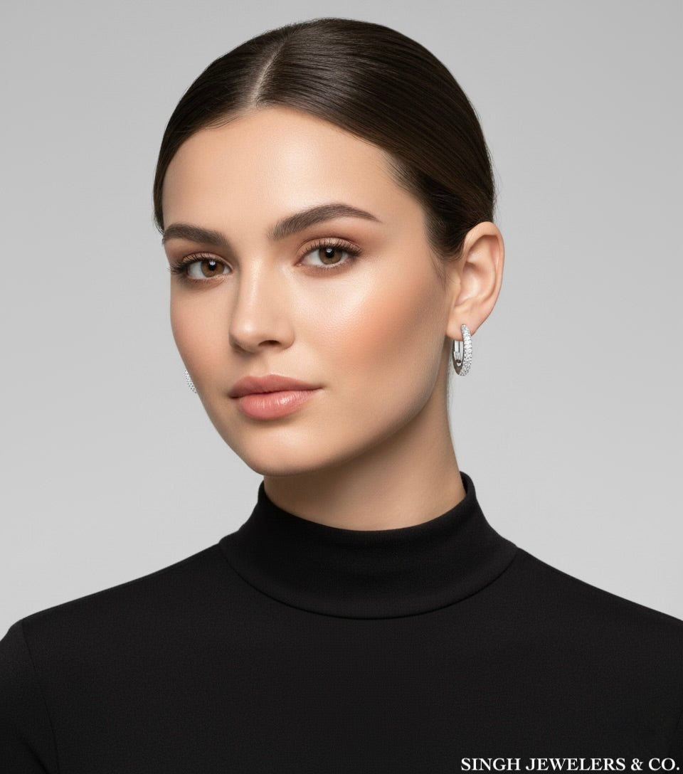 Woman wearing a black turtleneck with a neutral background, featuring Singh Jewelers & Co. branding.