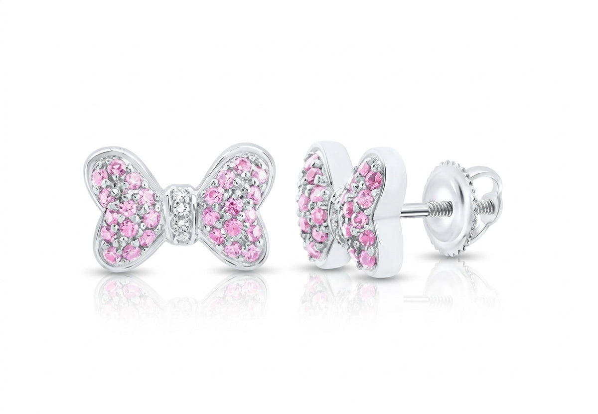 14K white gold pink sapphire and natural diamond bow earrings modeled on the ear on white background