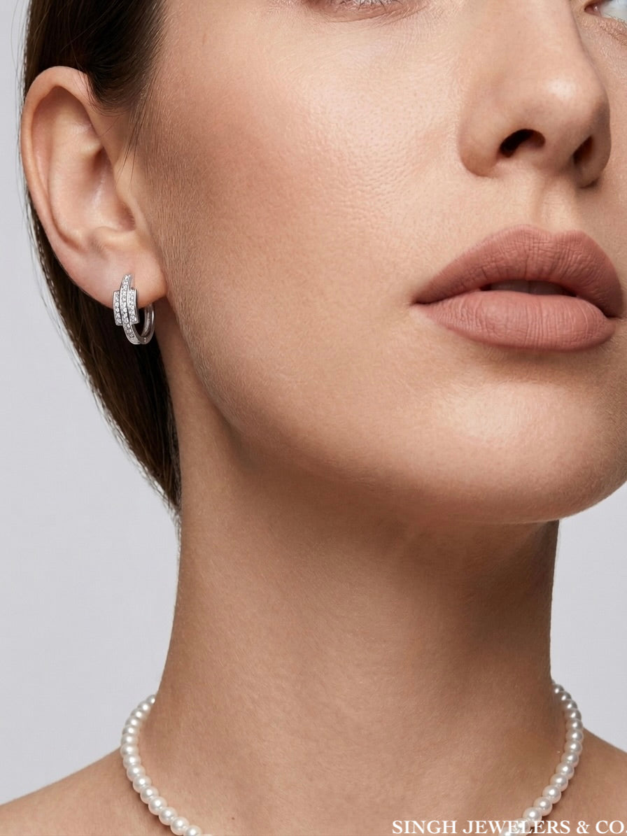 14K White Gold Round Cut Diamond Ladies Hoop Earrings featuring genuine round brilliant diamonds set in polished white gold hoops on a woman.