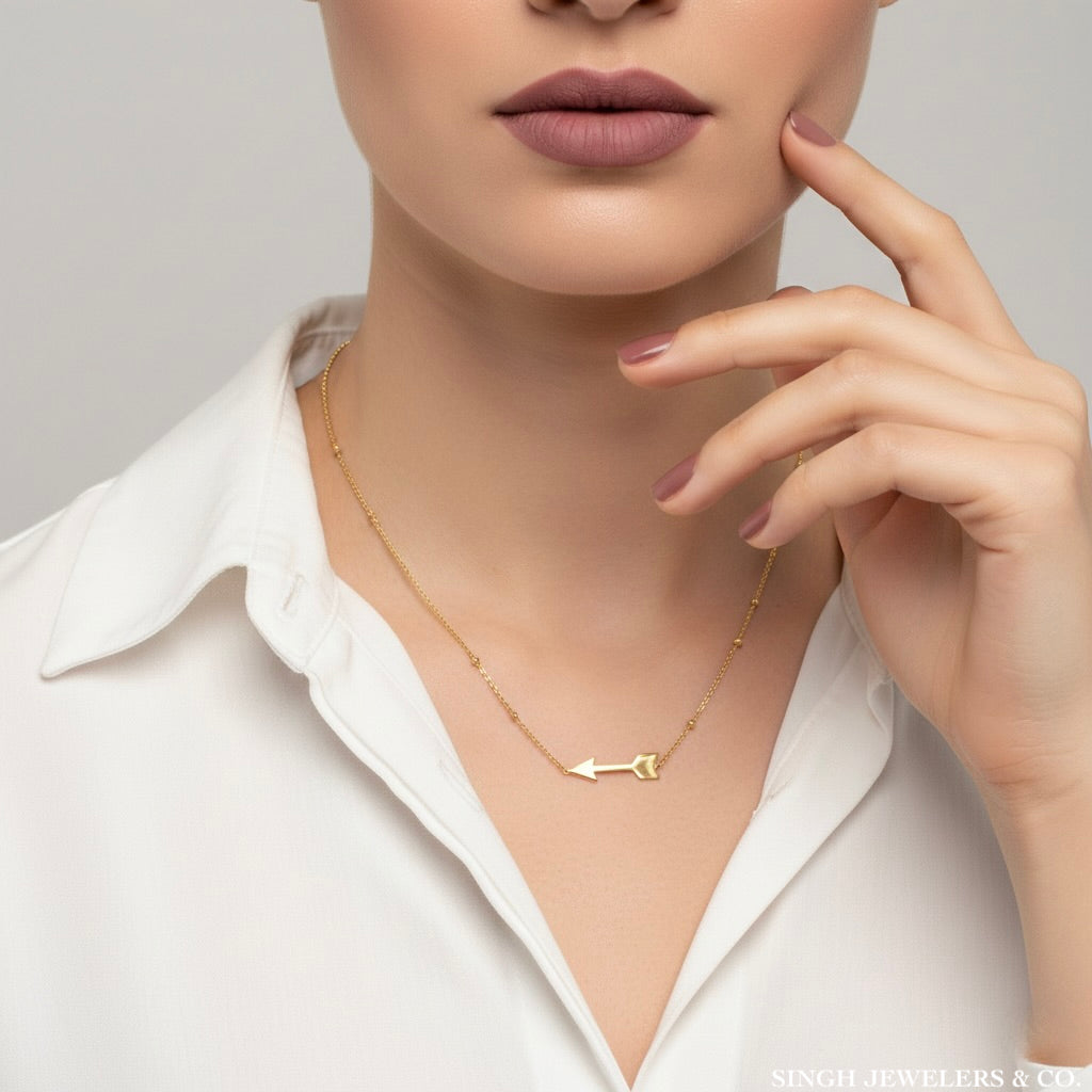 Symbolic arrow necklace in 14K gold on model