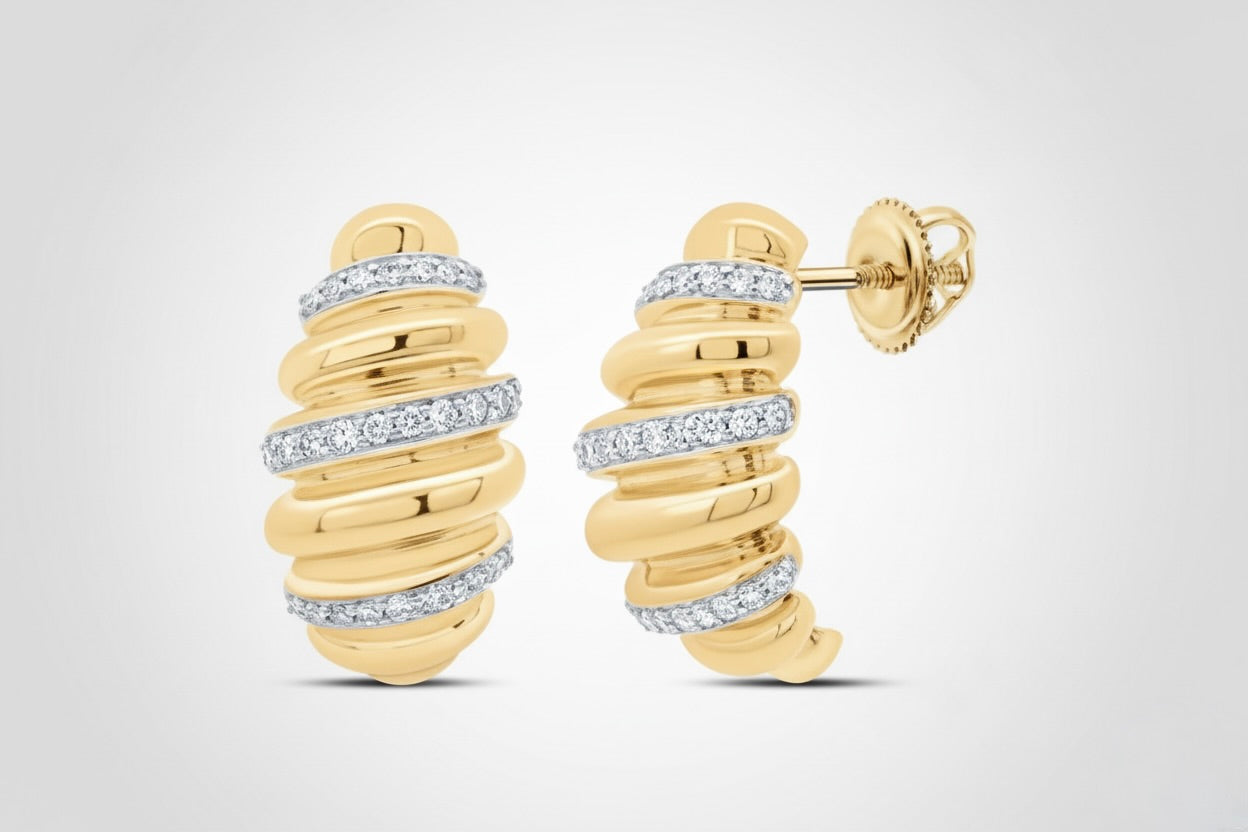 Gold hoop earrings with diamond accents on a light gray background