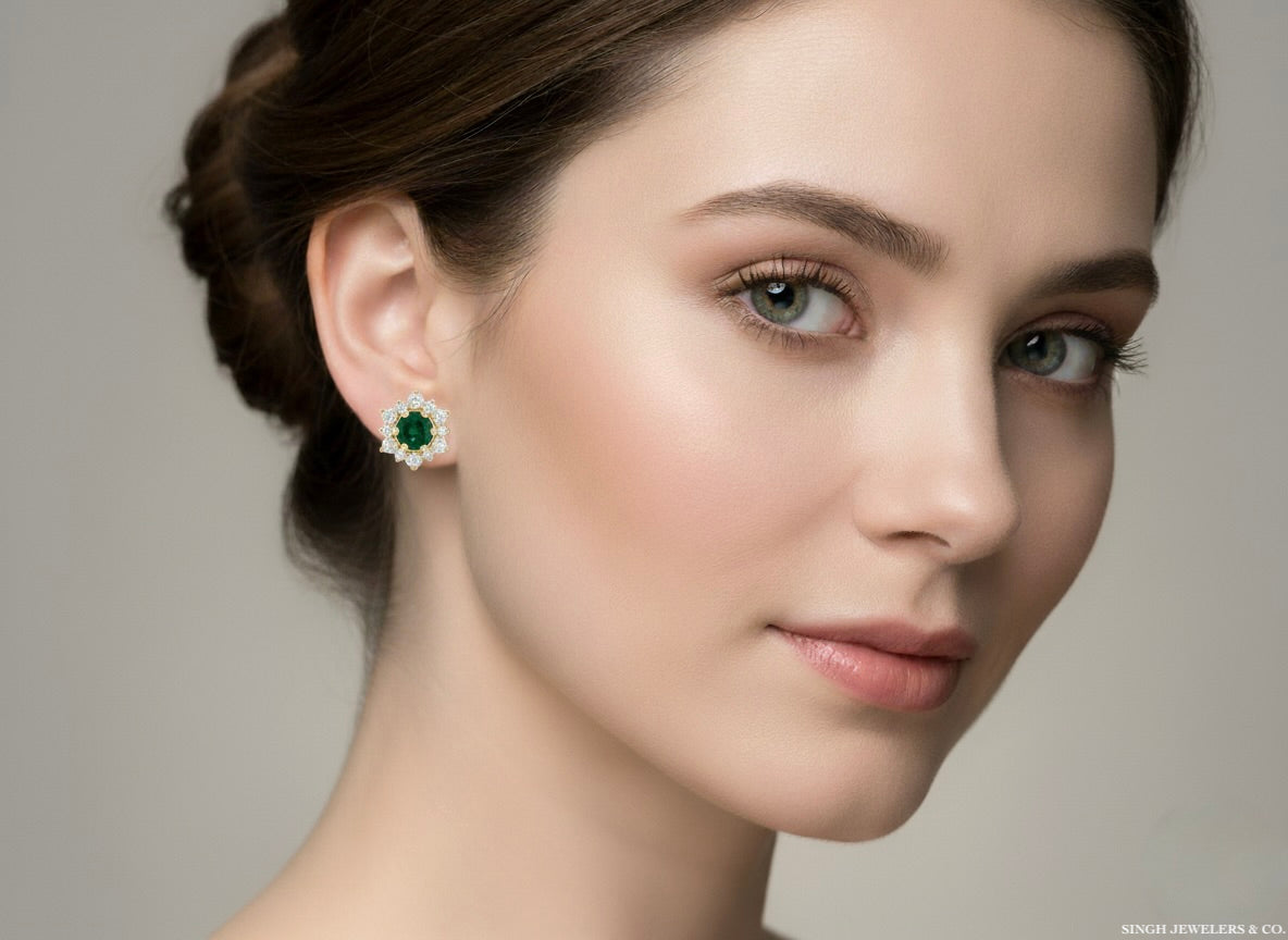 Close-up of a woman wearing a green gemstone earring against a neutral background