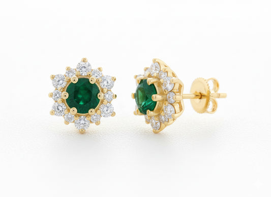 Gold earrings with green gemstones on a white background