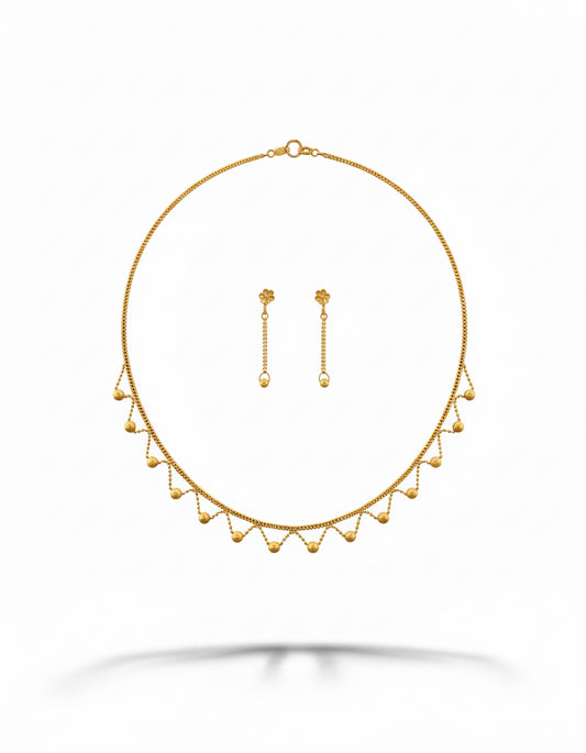 Gold necklace and earrings set on a white background