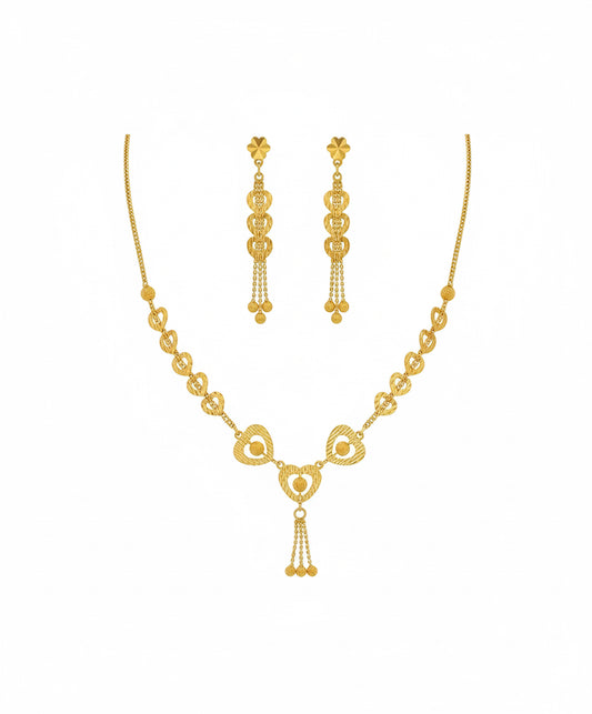 Gold necklace and earrings set on a white background