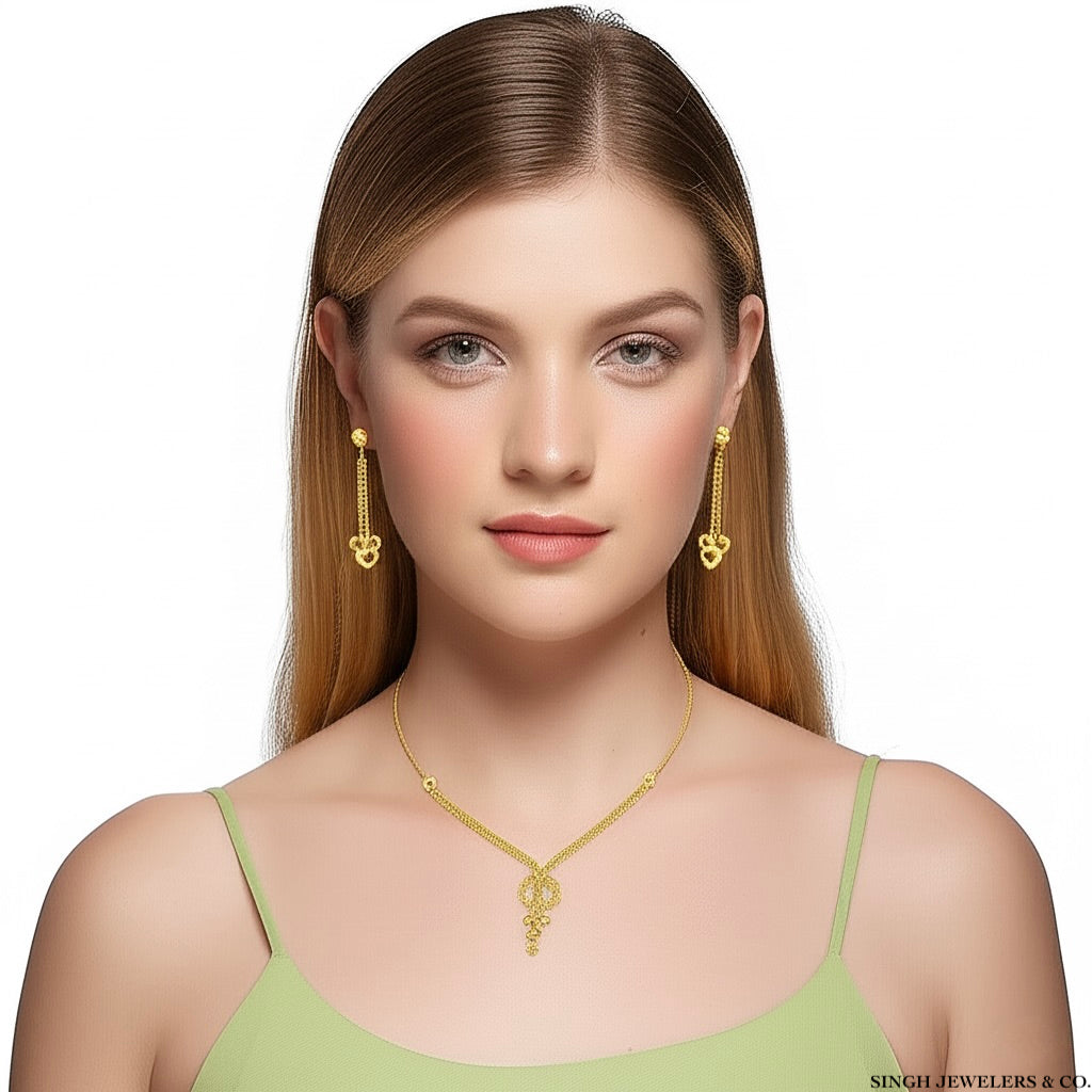 Woman wearing gold necklace and earrings on a white background