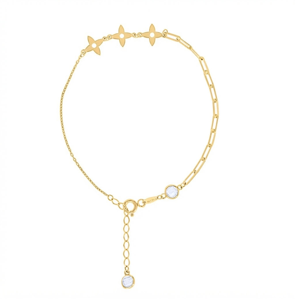 A delicate gold chain anklet featuring three star-shaped charms, a small oval bezel-set clear stone, an adjustable lobster clasp with extension chain, and a dangling charm ending in a round clear stone, shown on a plain white background.