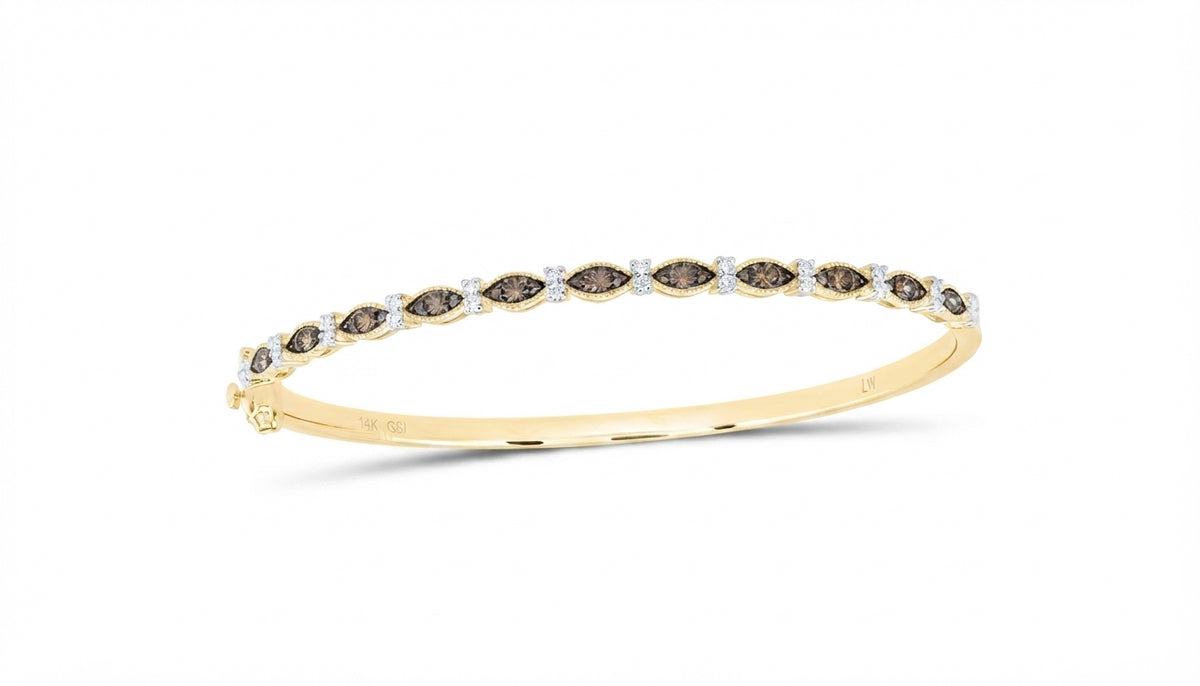 Close-up of natural cognac diamonds set in 14K yellow gold bangle