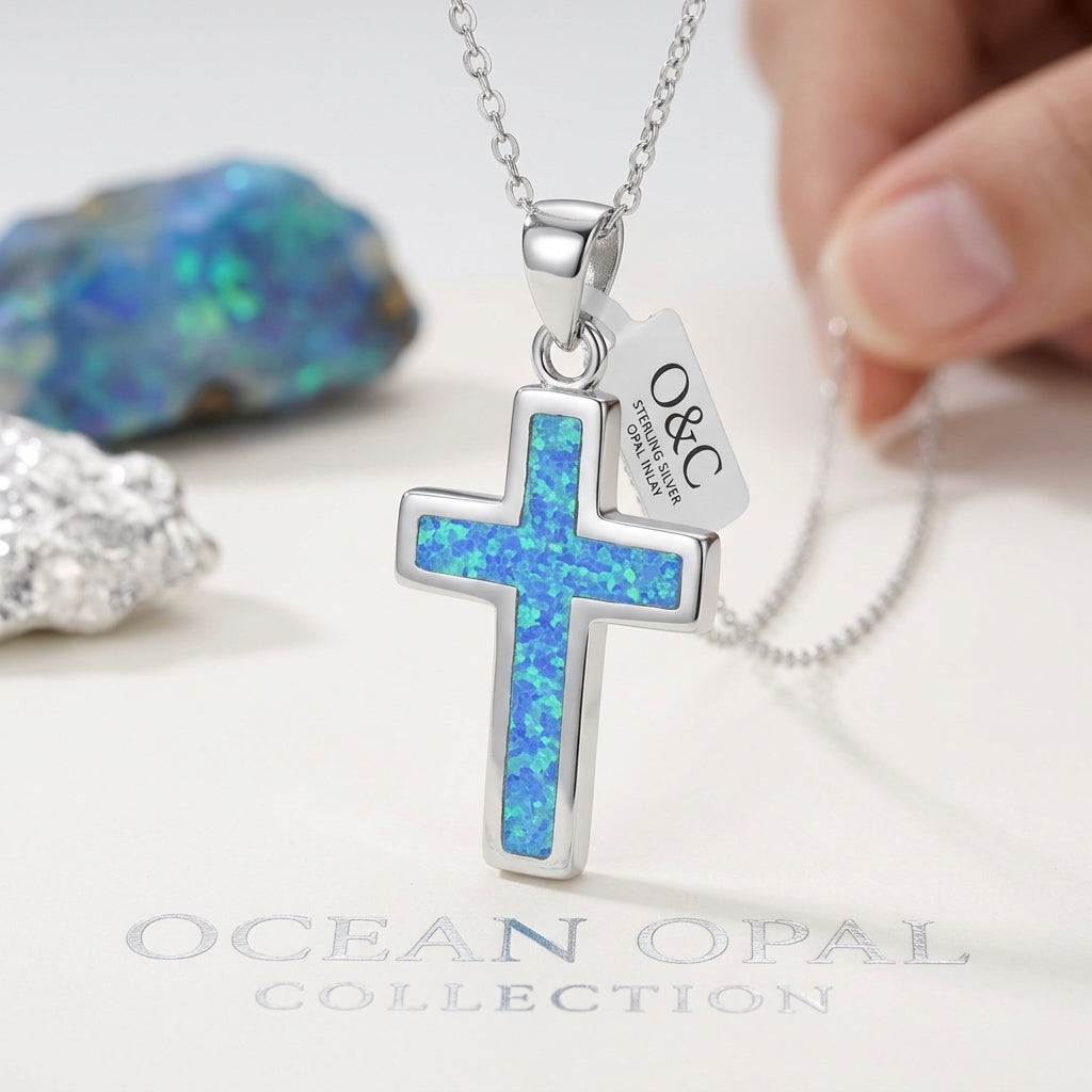 Close-up of blue opal details on a sterling silver cross pendant