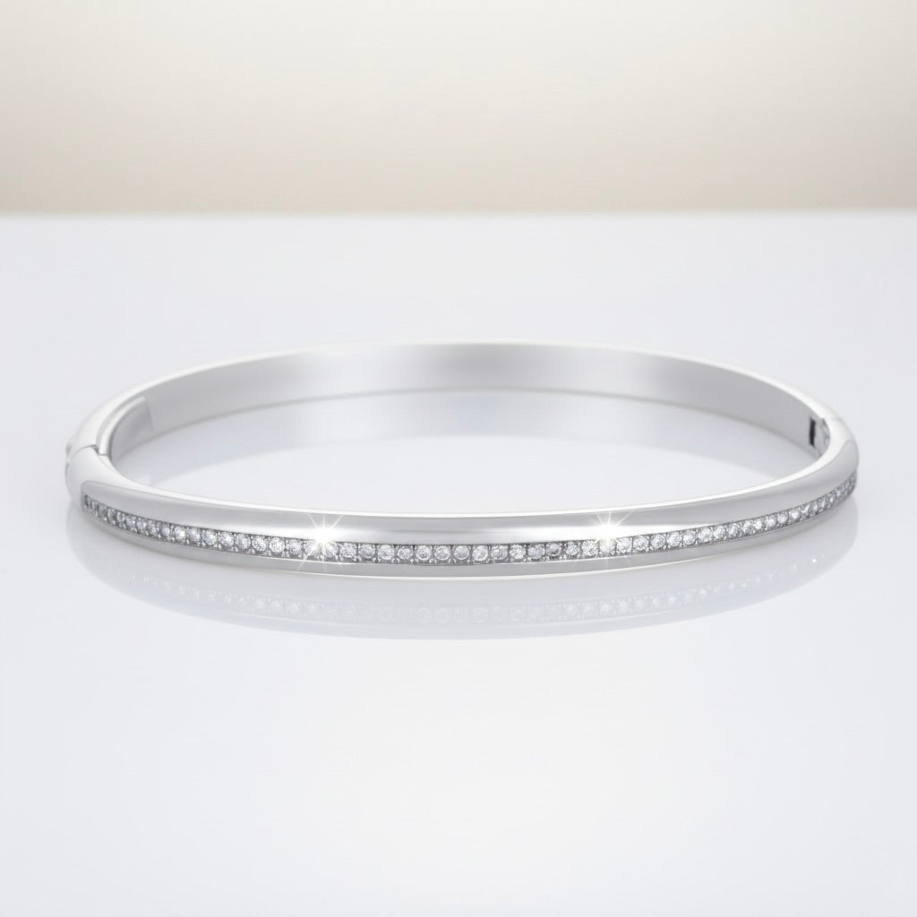 Silver bangle with small stones on a white background