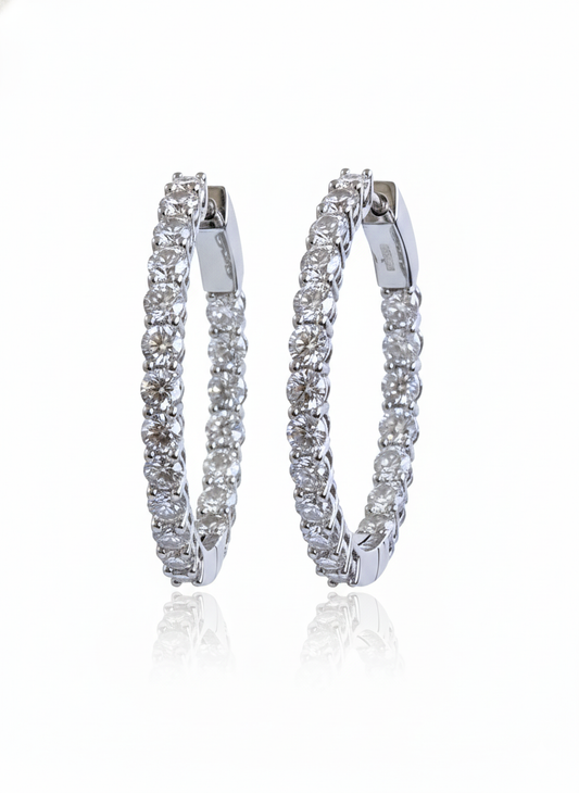 Pair of diamond hoop earrings on a white background