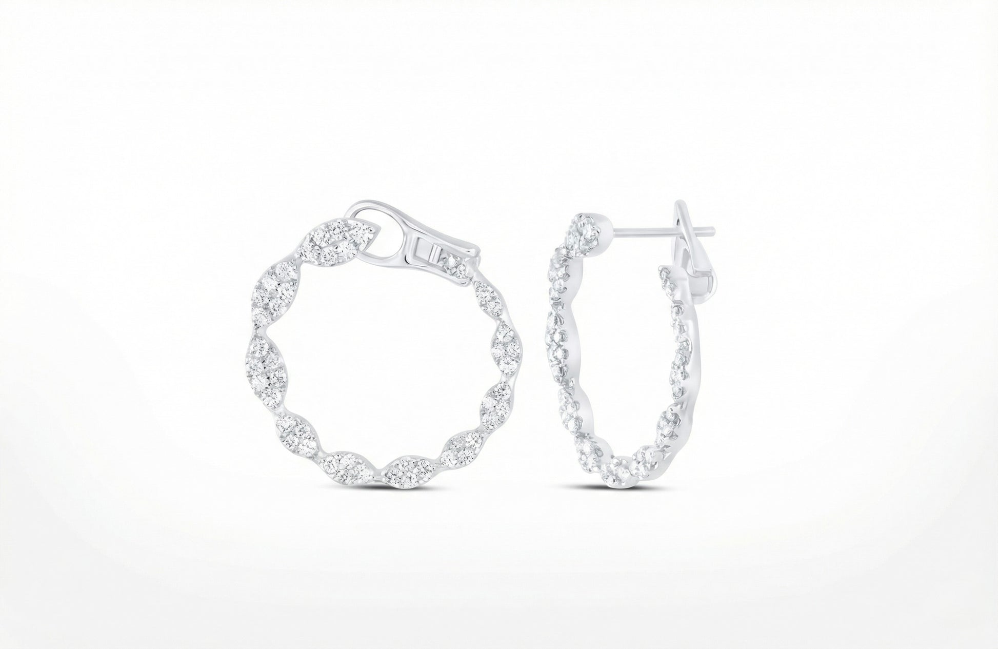 Pair of silver hoop earrings on a white background