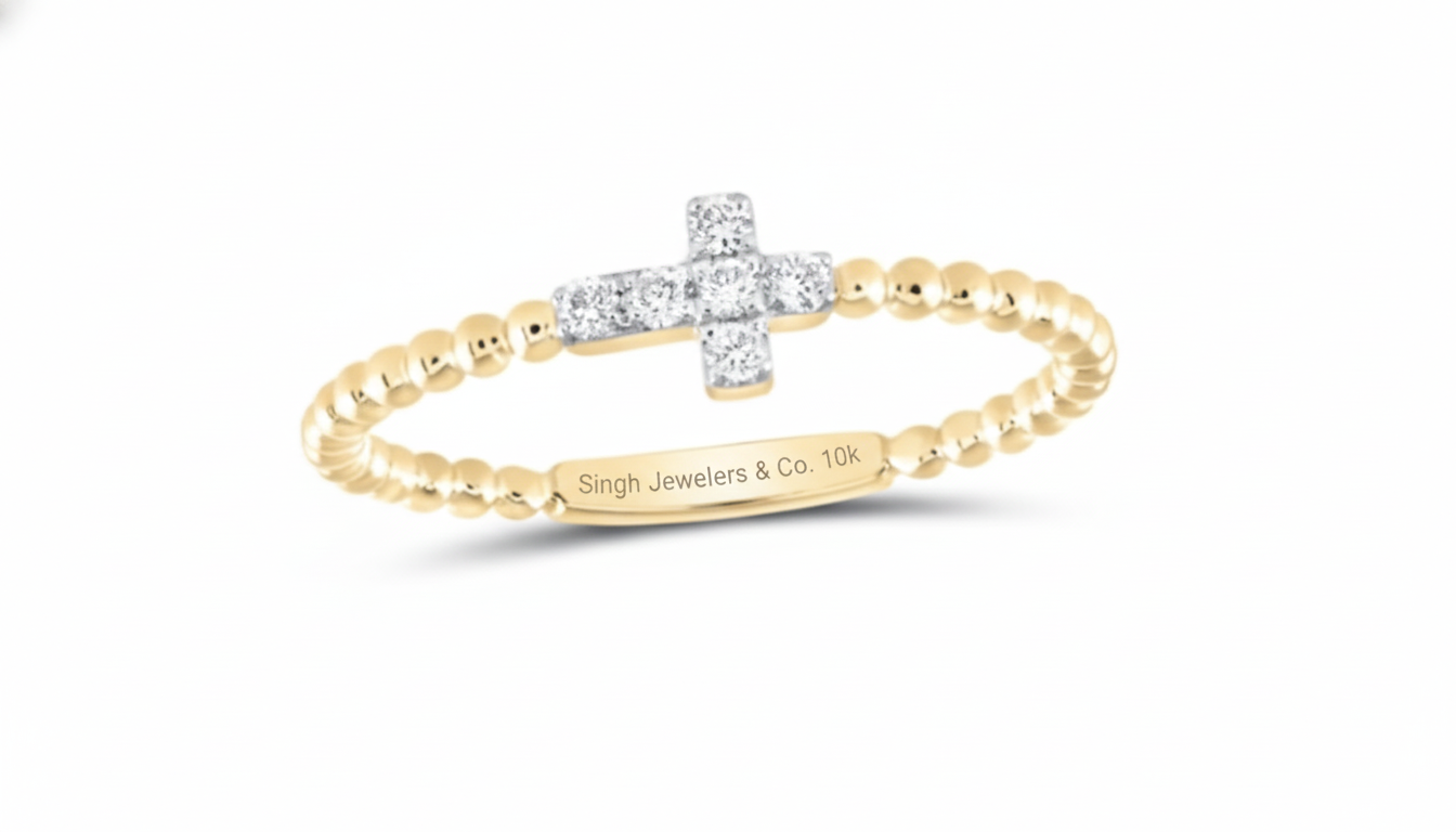 Gold and silver cross-shaped ring with 'Singh Jewelers & Co.' engraving on a white background