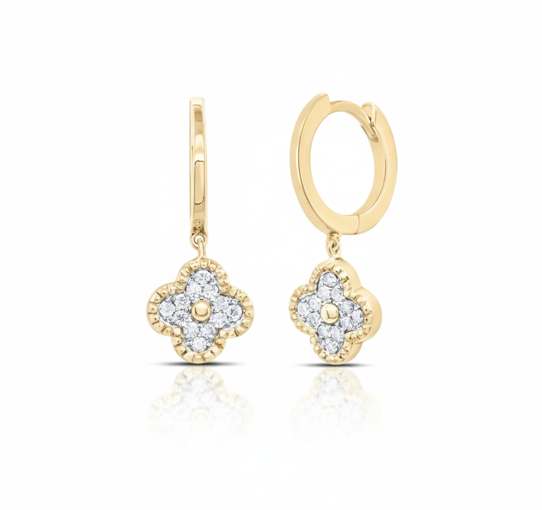 Gold earrings with diamond accents on a white background