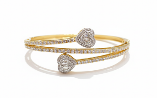 Gold and silver heart-shaped bangles on a white background