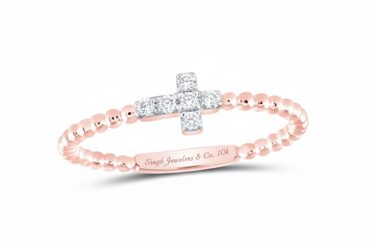 Rose gold ring with a diamond cross on a white background