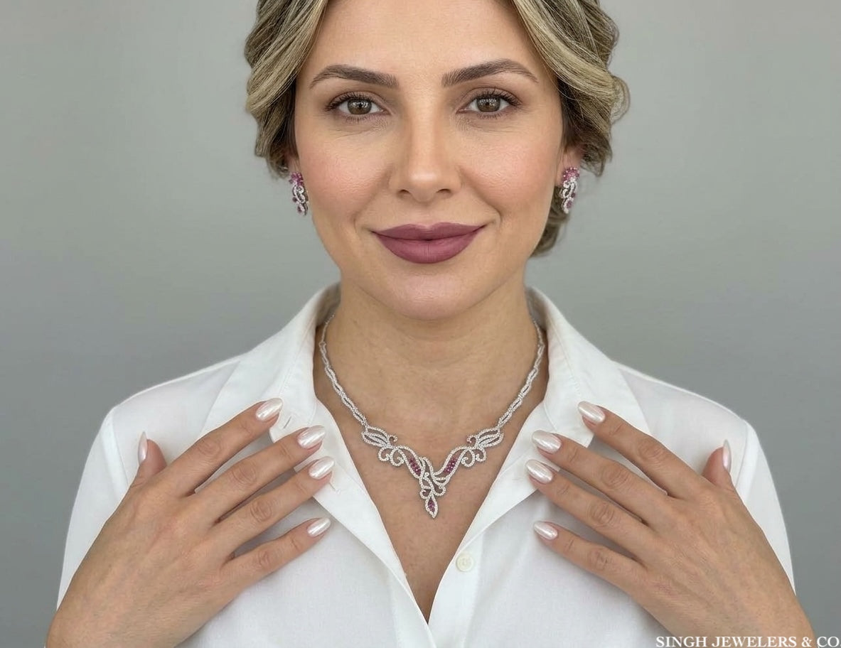 Sterling silver 925 necklace and matching earrings featuring pink and white sapphires on a woman