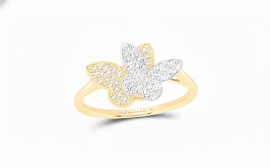 Gold and silver butterfly ring on a white background