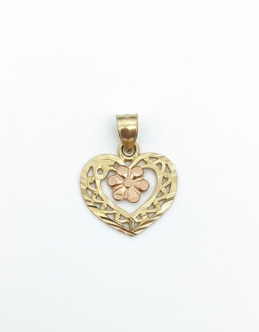 Gold heart-shaped pendant with floral design on a white background