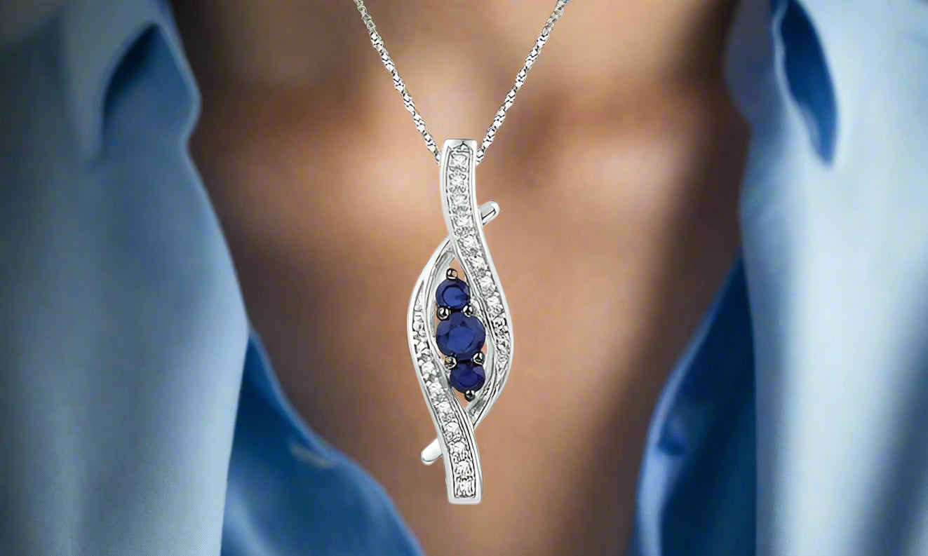 10K White Gold Blue Sapphire and Diamond Pendant on 20" Twisted Chain.
