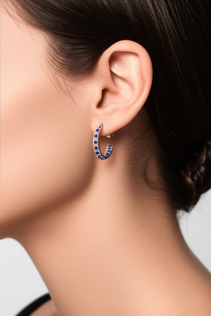 Model wearing sterling silver blue sapphire CZ hoop earrings