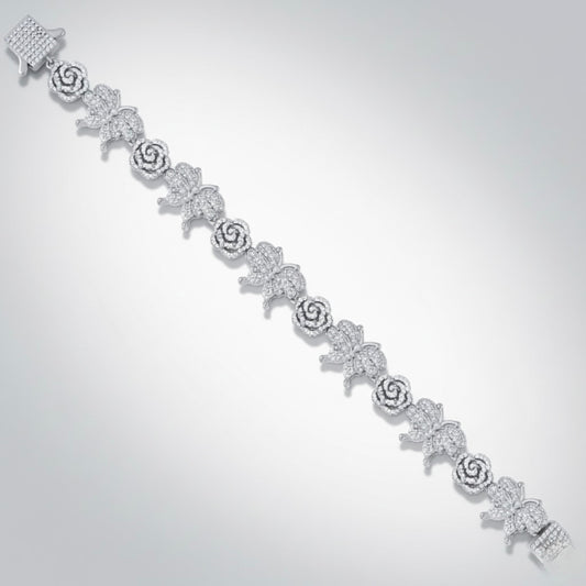 Silver bracelet with floral designs on a light gray background