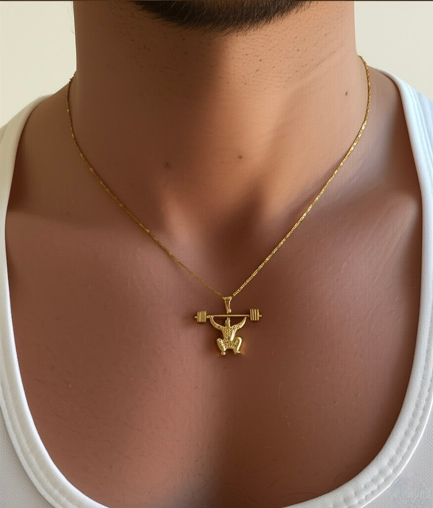 Close-up showing muscle detail on gold gym pendant