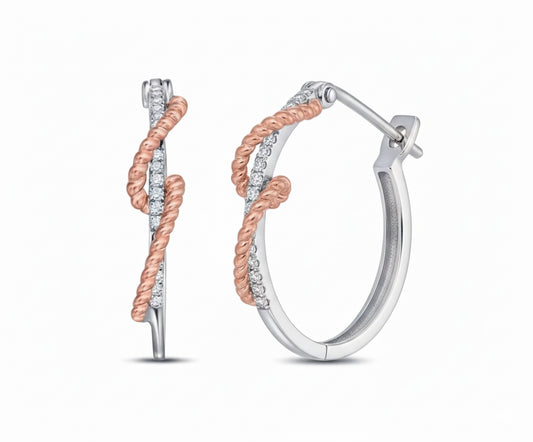 Pair of hoop earrings with rose gold and silver finish on a white background