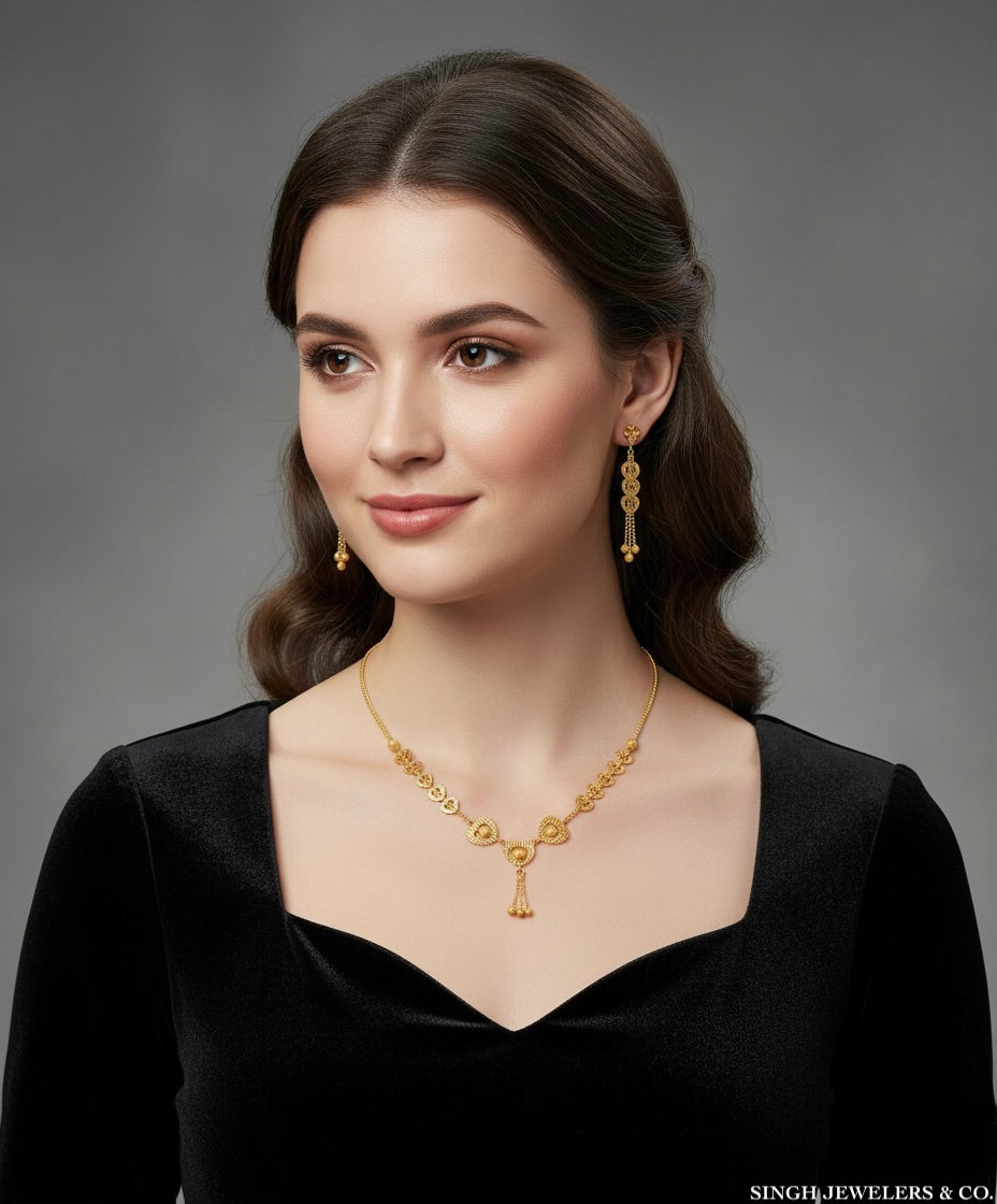 Woman wearing gold jewelry against a gray background